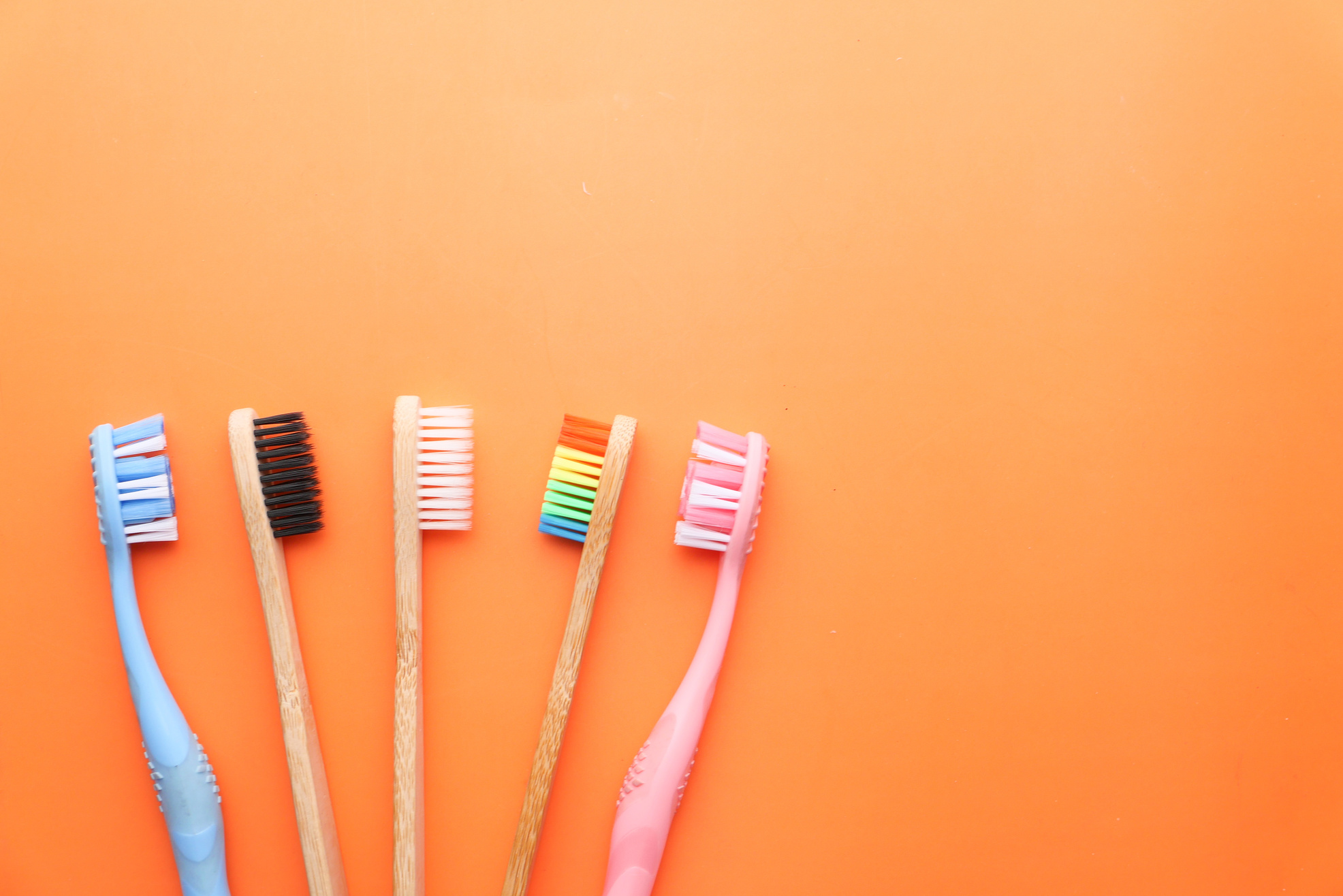 Close up of Colorful Tooth Brush on Orange Background.